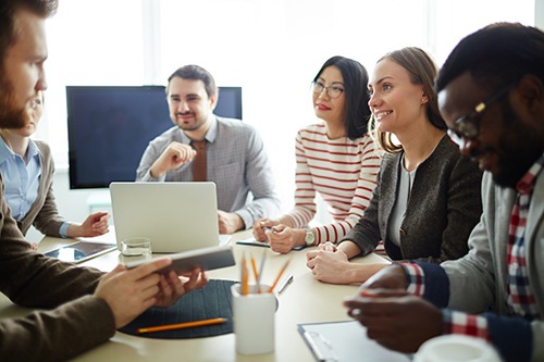 6 people having a meeting at a conference table. Covenant Care